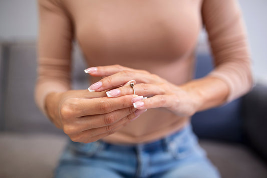 young women wearing a ring to see if it fits or not