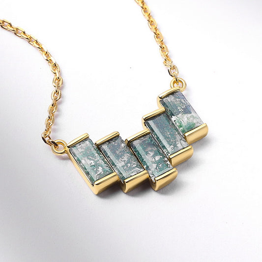 Gold - toned necklace: Geometric pendant with rectangular moss agate stones, isolated on white with soft shadows.