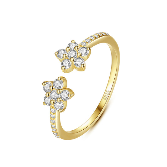Gold ring with cubic zirconia accents on a white background