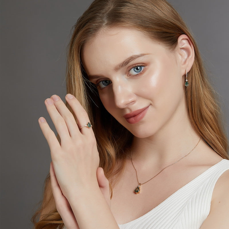 pairing pear moss agate dangle earrings and ring on women's hand