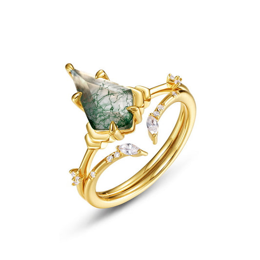 Gold ring: Teardrop moss agate center, crystal - adorned branches, isolated on a white background.