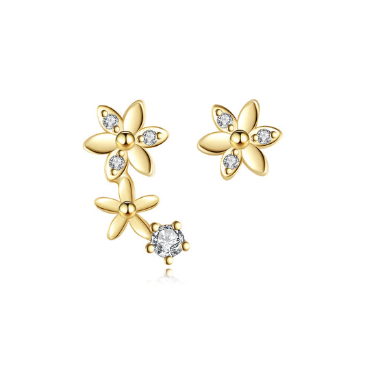 Gold flower-shaped earrings with clear gemstones on a white background