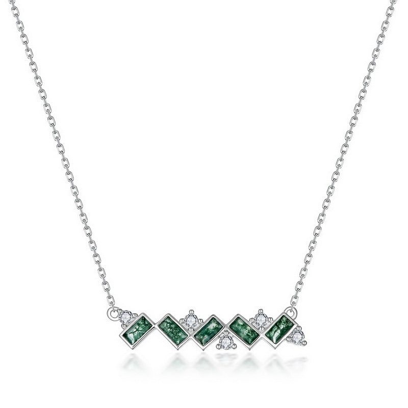 Silver - toned necklace: Horizontal pendant, green moss agate stones, clear crystal accents, isolated on gray.