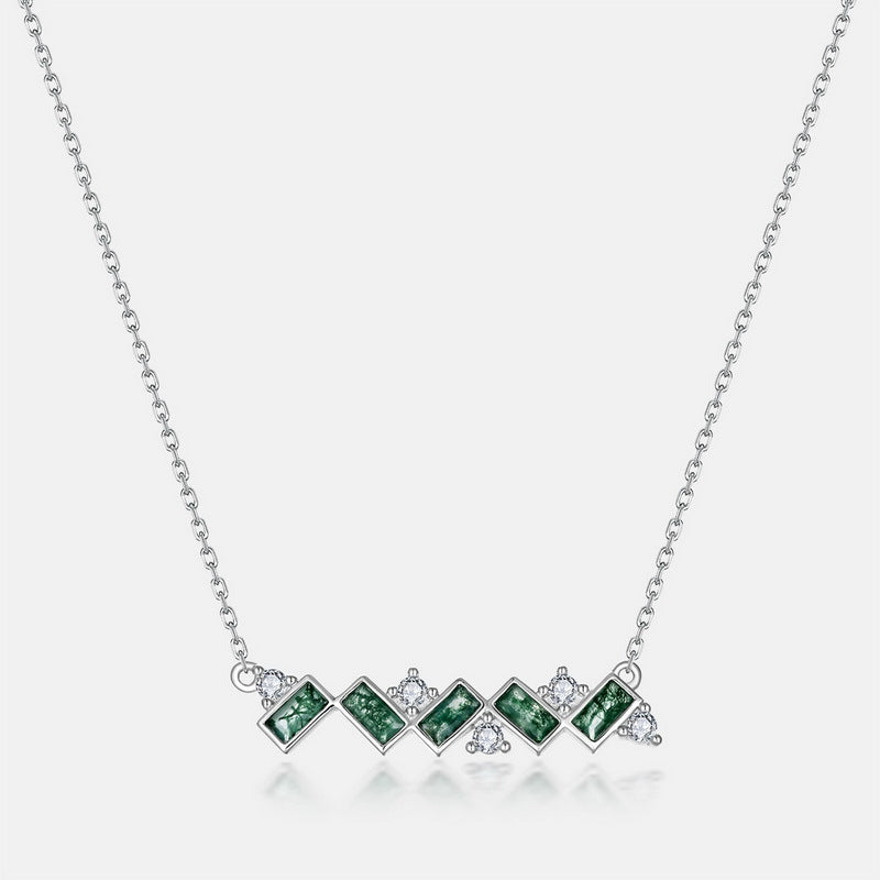Necklace with green gemstones on a white background