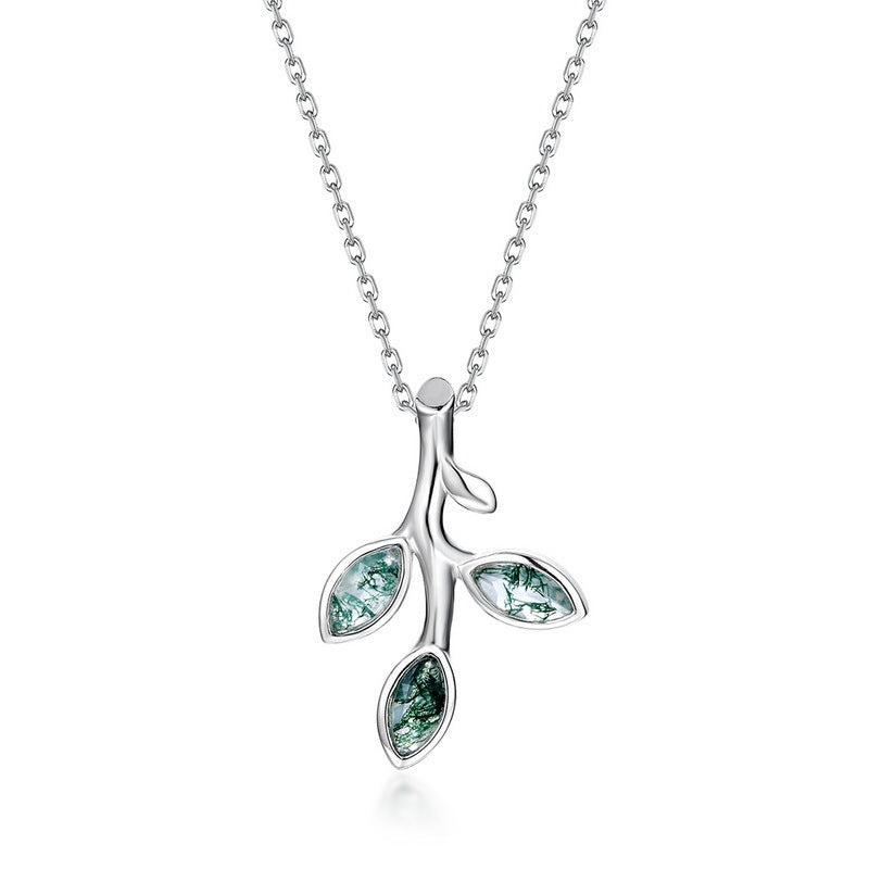 Nature inspired Silver necklace: Branch - shaped pendant, three leaf - like settings with green moss agate, isolated on gray.