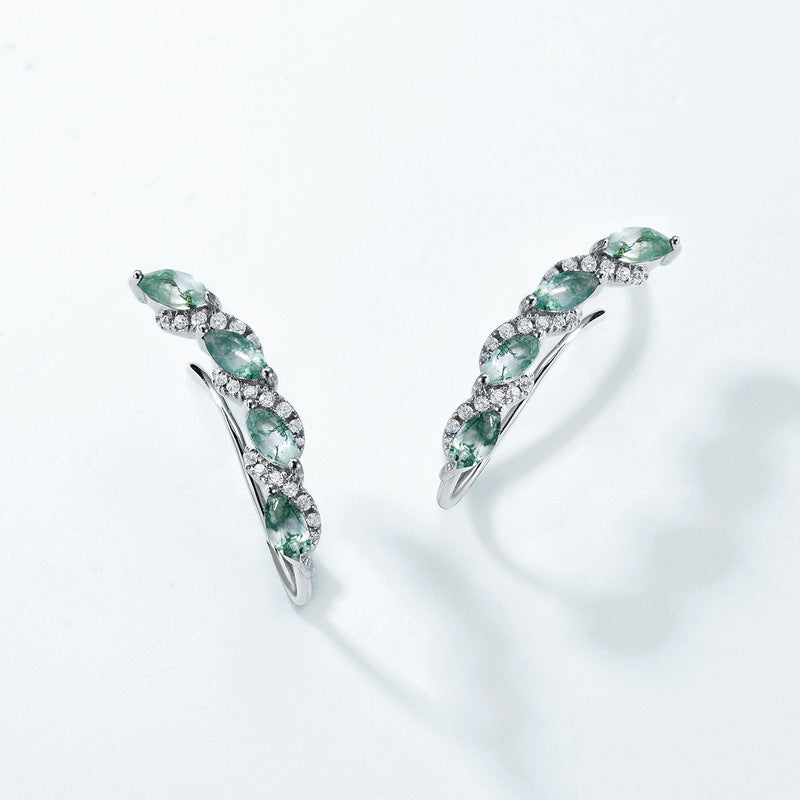 Silver - toned earrings: Marquise moss agate stones, crystal accents, curved vine design, isolated on white.