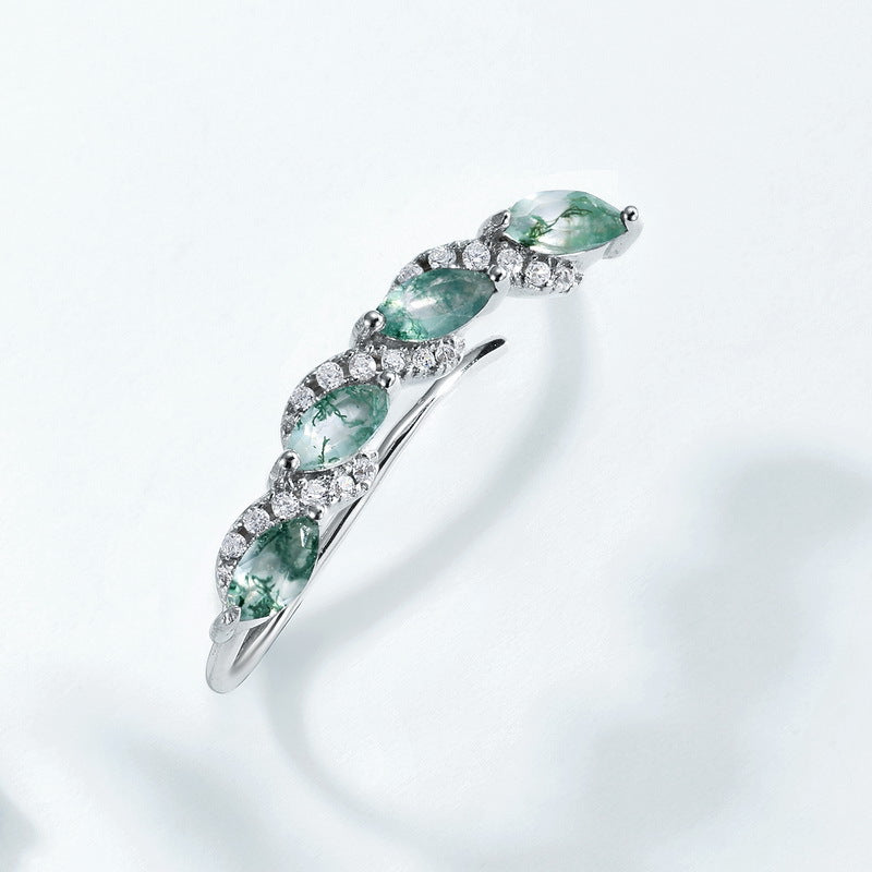 Silver - toned ring: Marquise moss agate stones, crystal accents, curved vine design, isolated on white.