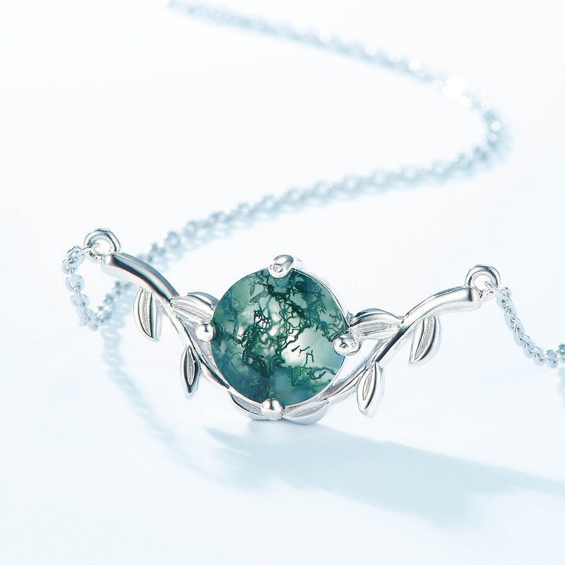 Silver - toned necklace: Round moss agate pendant, leaf - shaped design, isolated on white.