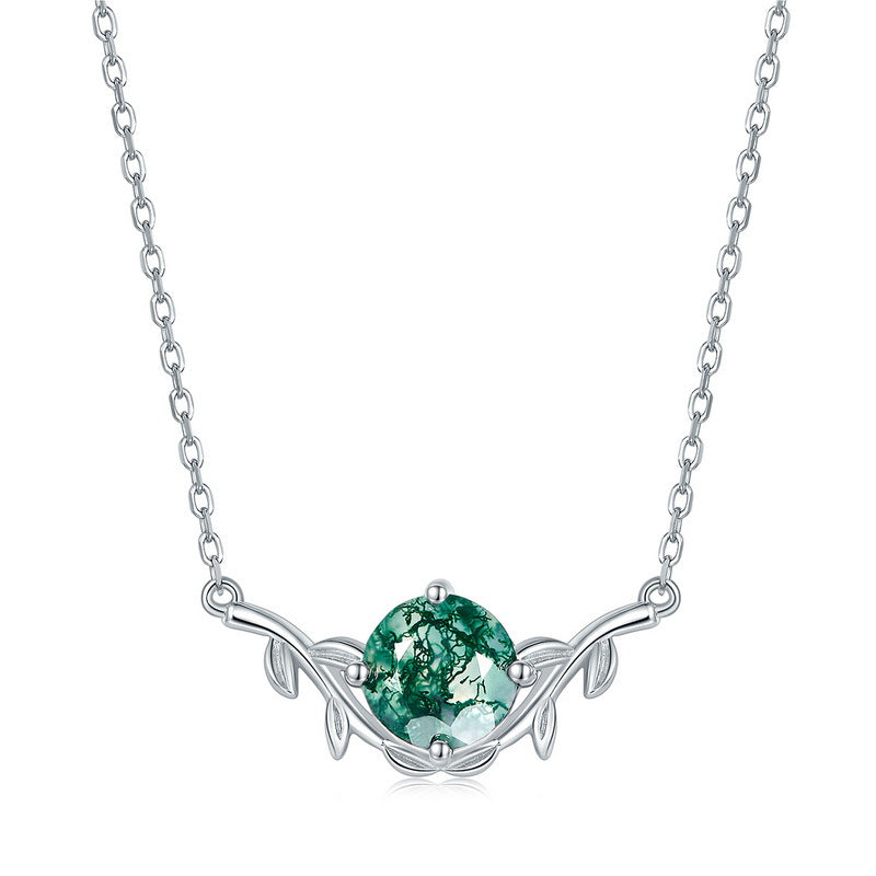 Silver necklace with a green gemstone pendant on a white background