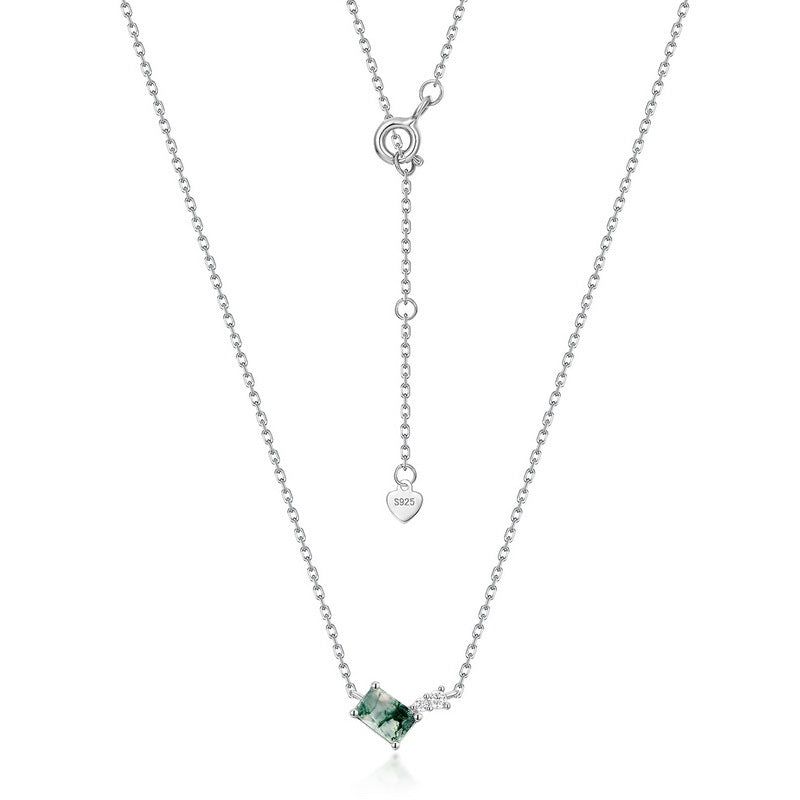 Silver - toned necklace: Rectangular moss agate pendant, small clear crystal accent, adjustable chain with “S925” heart tag, isolated on white.