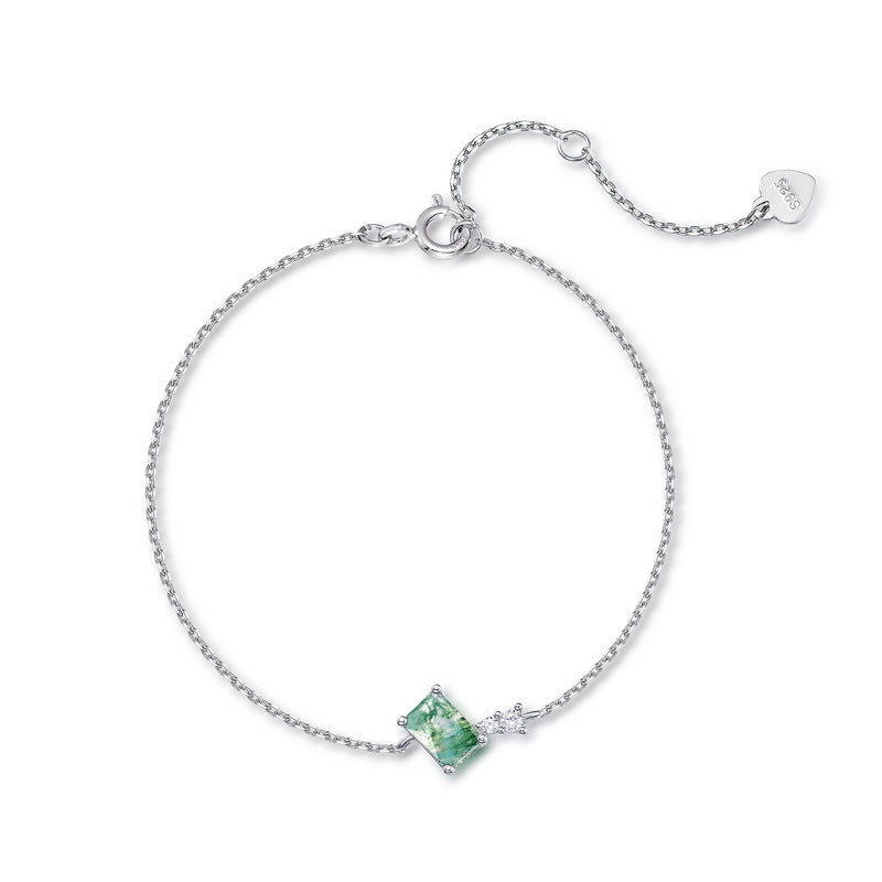 Silver bracelet: Rectangular moss agate, clear crystal accent, chain with “S925” heart tag, white background.