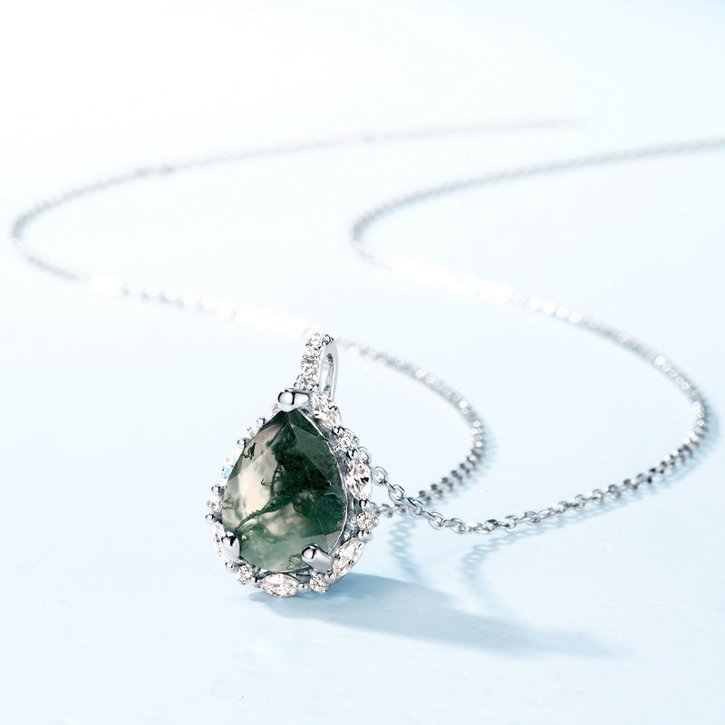 Silver pendant necklace: Teardrop - shaped moss agate, clear crystals, light blue background, showcasing the pendant and chain.