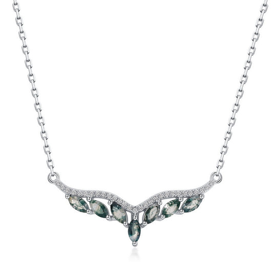 Silver - toned necklace: V - shaped pendant with marquise moss agate stones, crystal accents, isolated on gray.