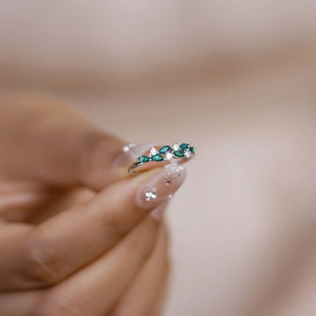 Silver ring with moss agate stones and cubic zirconia, held by hand with decorated nails, delicate jewelry for daily match