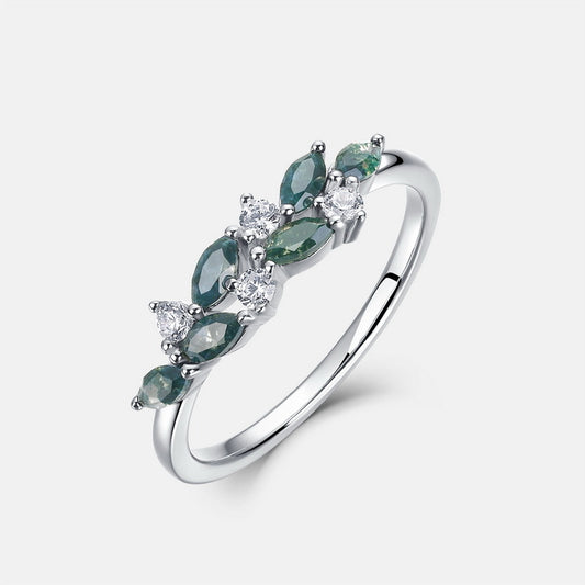 Silver - band ring adorned with marquise - cut moss agate and round cubic zirconia, isolated on white, elegant accessory design