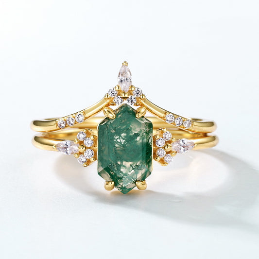 Gold - toned ring set: Hexagonal moss agate ring with crystal - decorated bands, isolated on white.