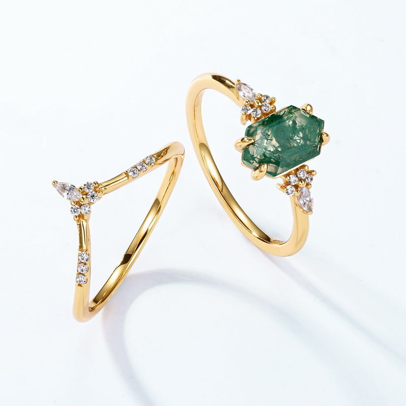 Gold - toned ring set: Hexagonal moss agate ring with multi - layer crystal - studded designs, isolated on white.
