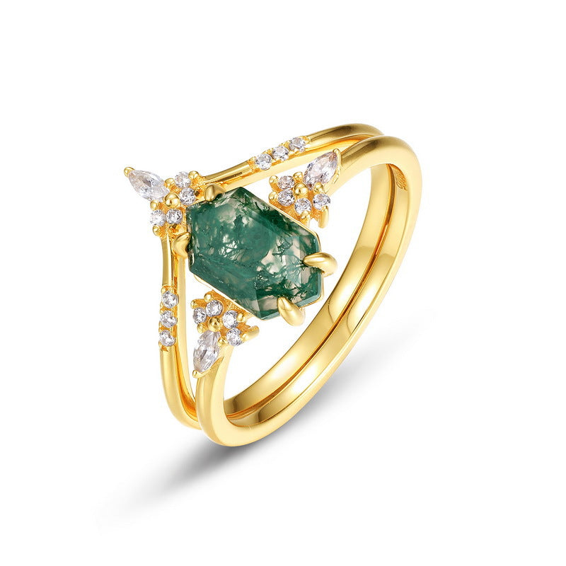 Gold - toned ring set: Hexagonal moss agate ring and geometric crystal - encrusted ring, isolated on white.