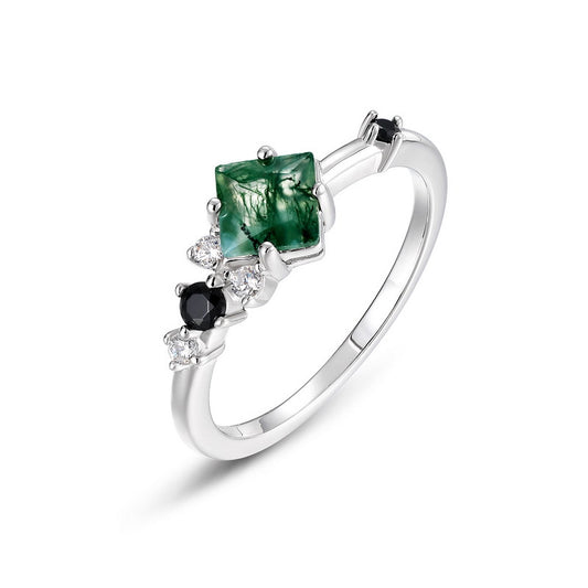Silver ring: Square moss agate design with black gemstones and clear crystals, isolated on a white background, showcasing sleek, modern styling.
