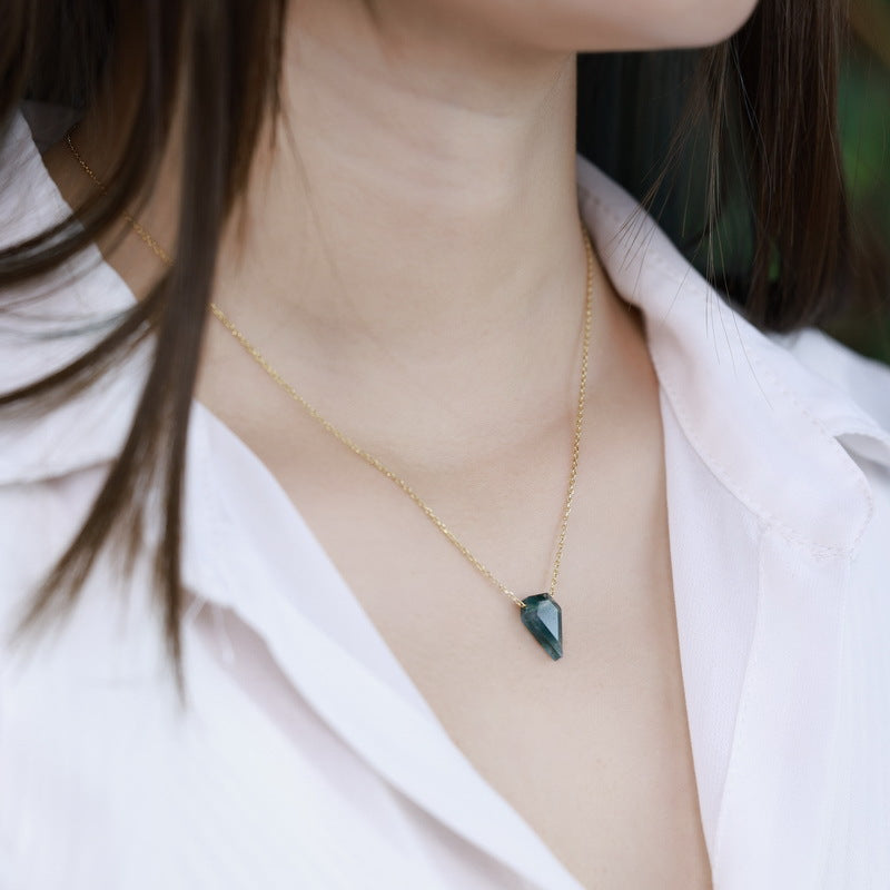 Close - up of a person wearing gold - toned necklace: Teardrop - shaped moss agate pendant, showcasing elegant style.