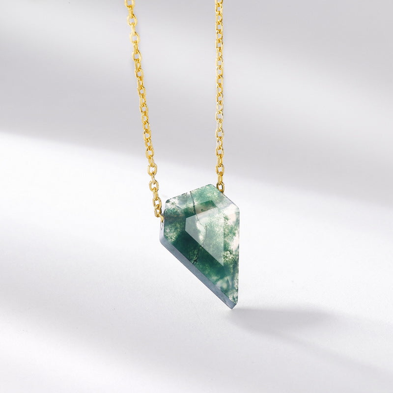 Necklace with a green moss agate pendant on a gold chain against a light gray background