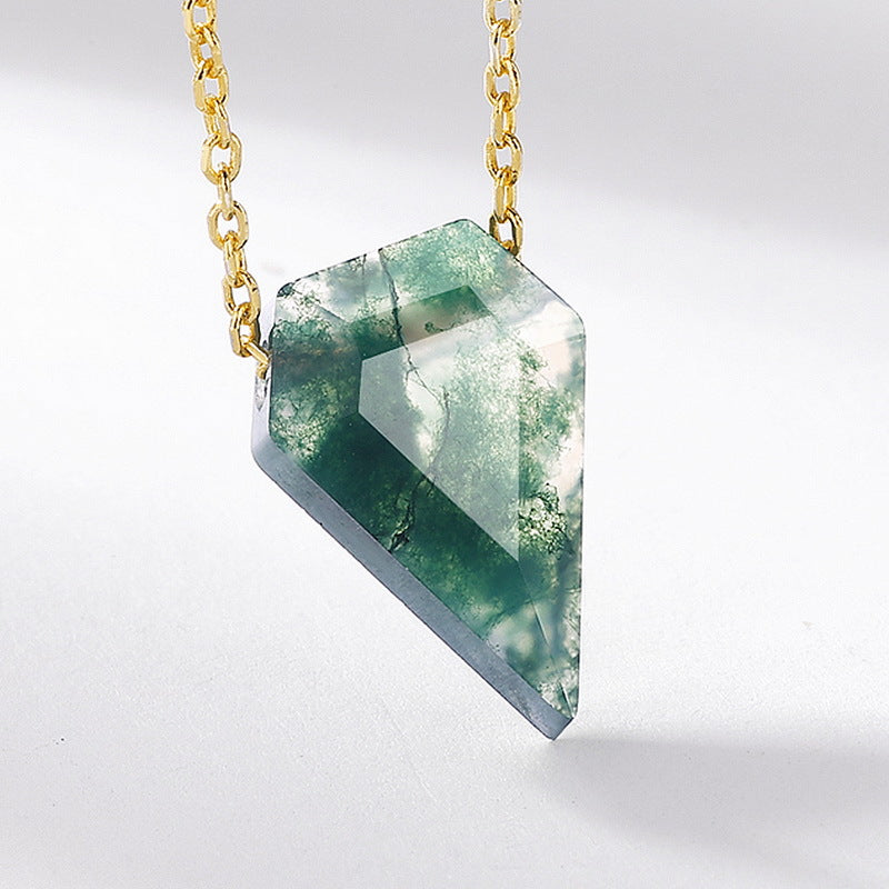 Extreme close - up of gold - toned necklace pendant: Teardrop - shaped moss agate stone, isolated on white, highlighting intricate details.