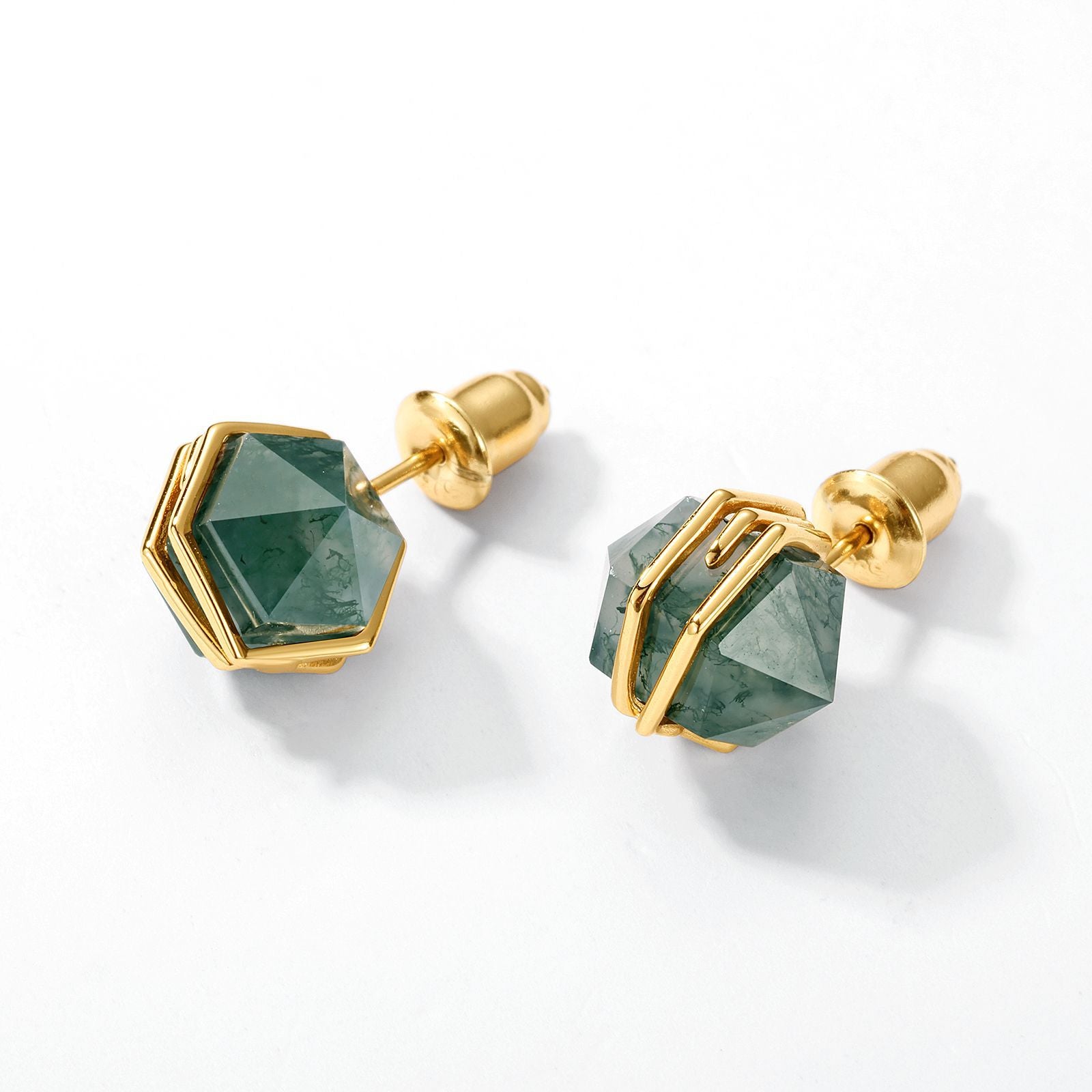 Gold - toned stud earrings: Hexagonal moss agate stones, geometric metal settings, isolated on a white background.