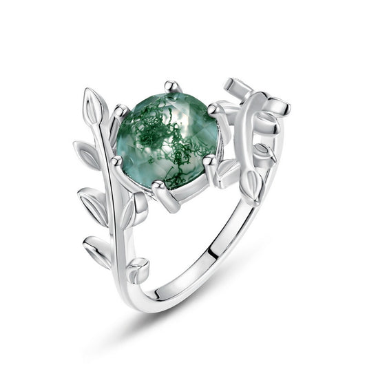 Silver ring: Round moss agate center, leaf - wrapped setting, isolated on white, showcasing fine craftsmanship