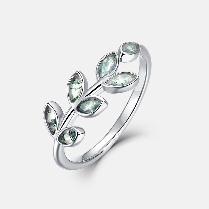 Silver leaf - patterned ring: Marquise moss agate stones, polished metalwork, isolated on white, showcasing fine design