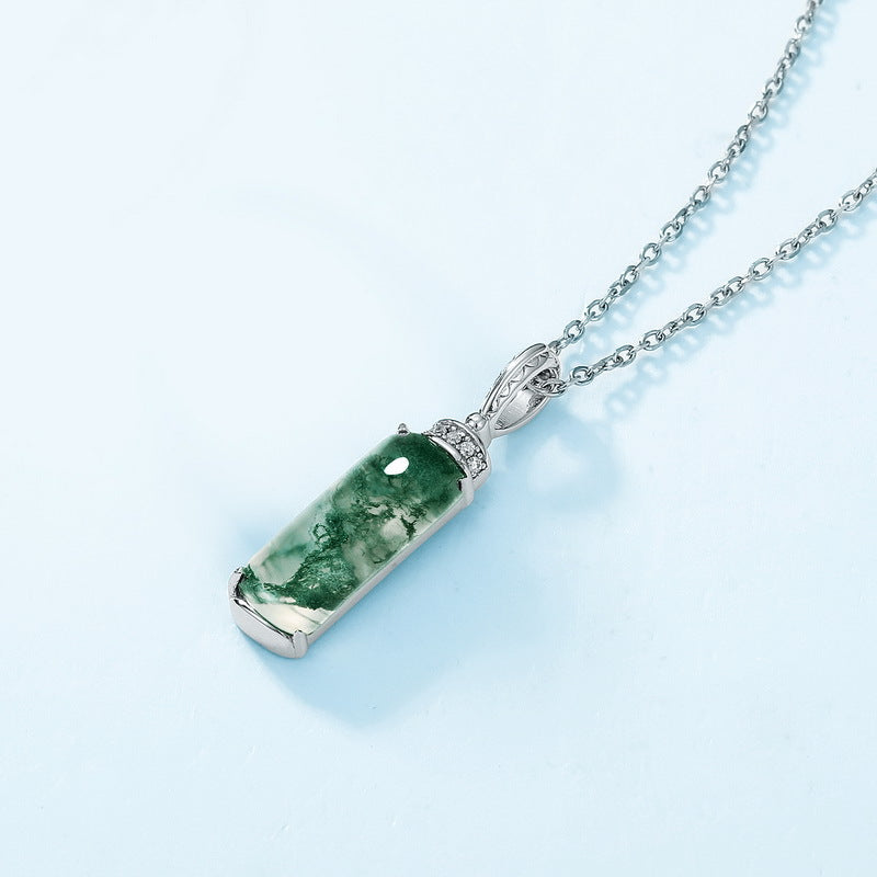 Silver pendant necklace: Rectangular moss agate, cubic zirconia - adorned top, isolated on light blue