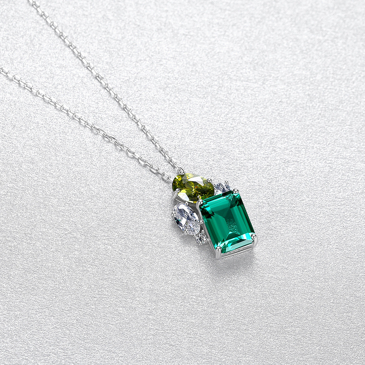 Green gemstone necklace on a light gray background