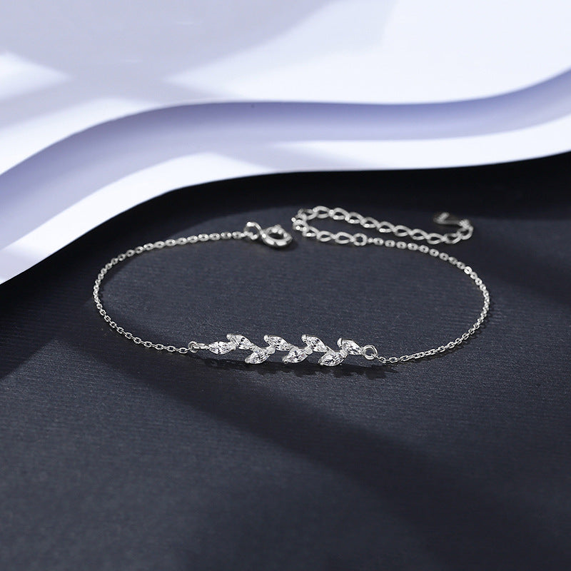 Silver bracelet with marquise small CZ with adjustable cable chain on a dark surface