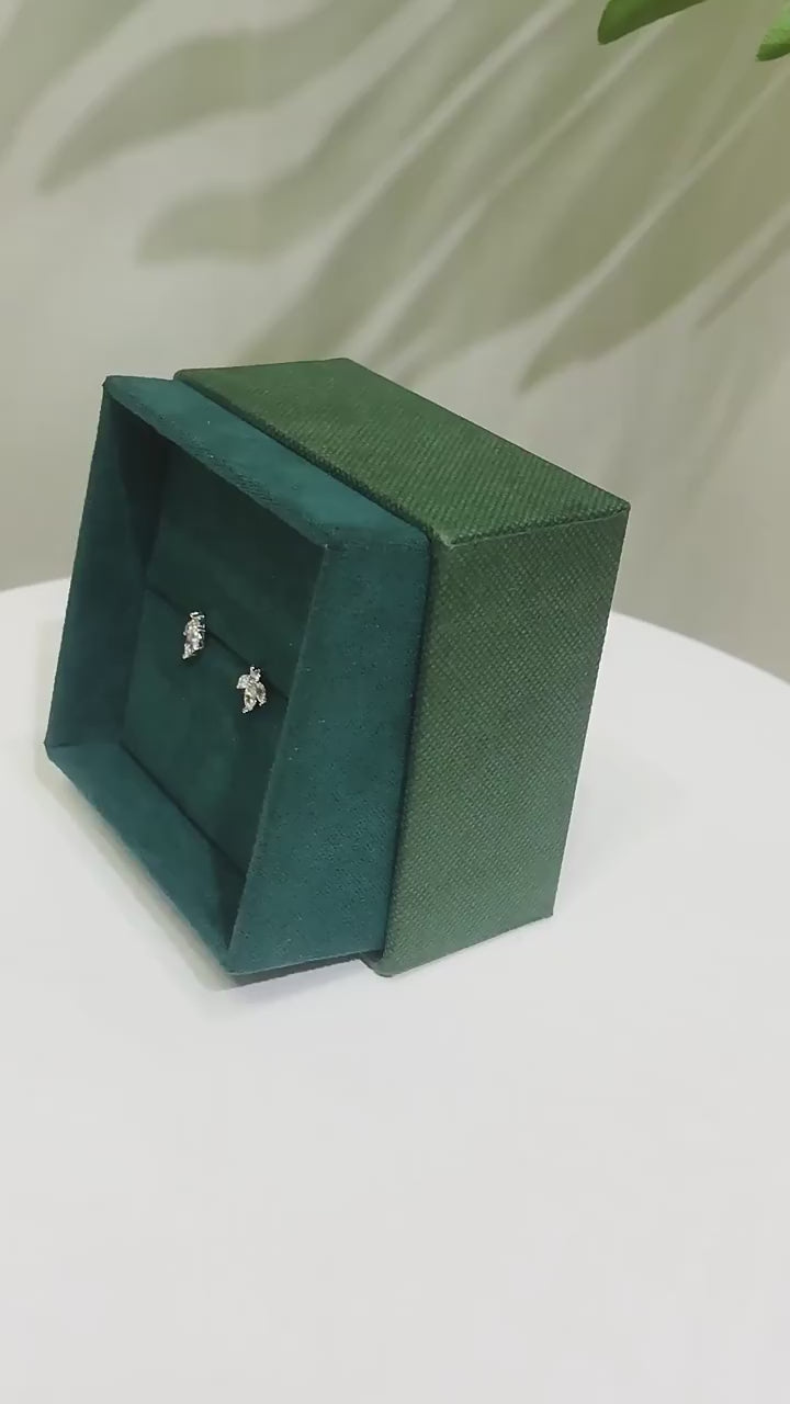 earrings on a green velvet box