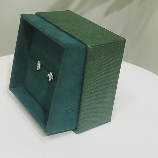 earrings on a green velvet box